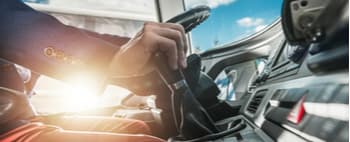 close up of a charter bus driver's hands on the wheel